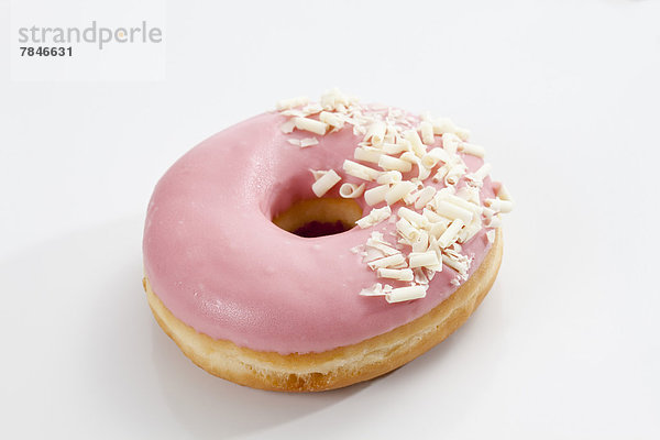 Doughnut topped with pink icing on white background  close up