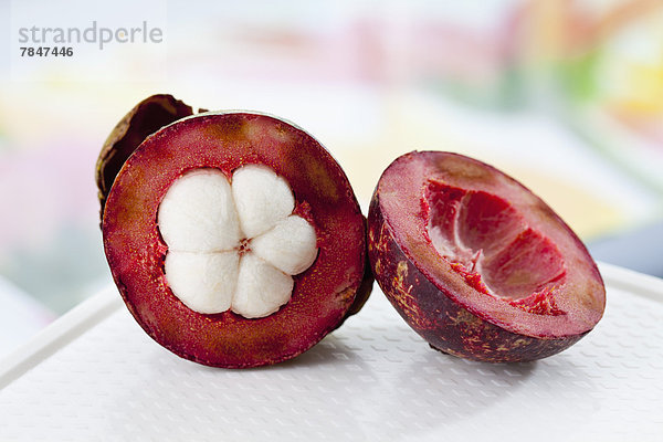 Mangosteen fruits on chopping board  close up