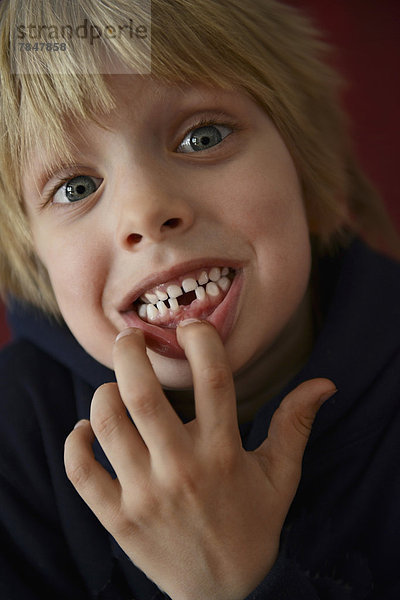 Austria  Boy showing tooth gap  close up