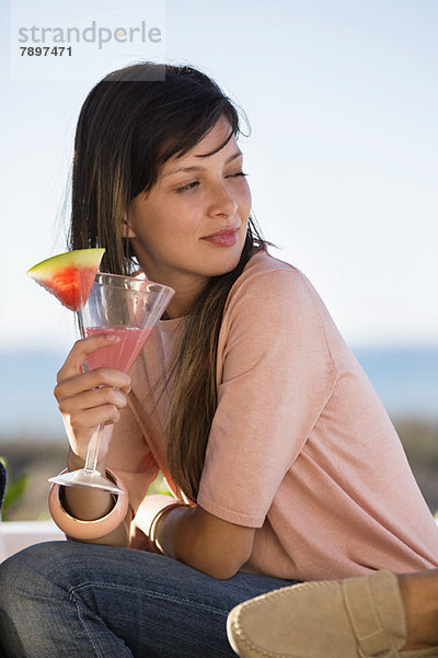 Frau trinkt Wassermelonen-Martini