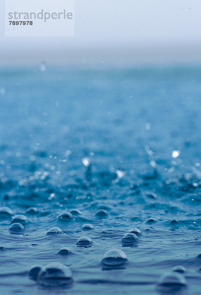Regentropfen fallen ins Meer