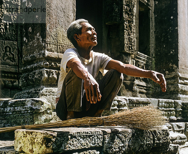 Bayon-Tempel  älterer Mann mit Reisigbesen auf der zweiten Terrasse