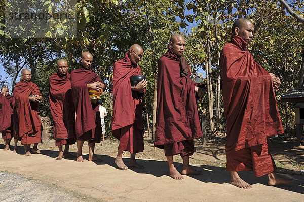 Buddhistische Mönche beim Sammeln von Almosen  Fest zum Dezembervollmond