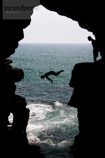 Außenaufnahme  Mann  Ozean  Höhle  jung  springen  Tanger  Atlantischer Ozean  Atlantik  marokkanisch  Marokko