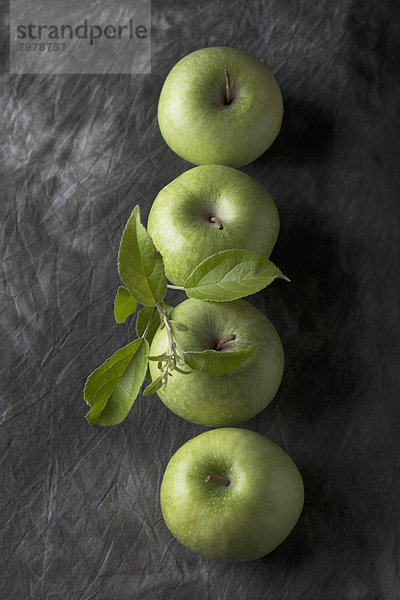 Green apples with leaves  close up