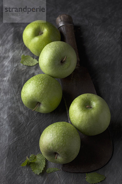 Green apples with sickle  close up