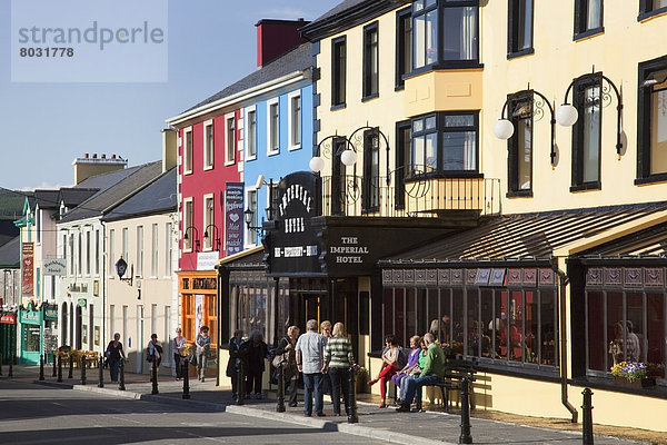 Pedestrians walking beside colourful buildings Lisdoonvarna county clare ireland