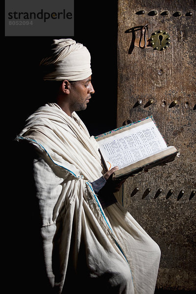 Ethiopian Orthodox priest reading bible  Lalibela  Northen Ethiopia