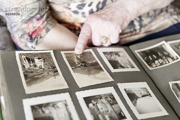 Alte Frau schaut in ein Fotoalbum  close-up