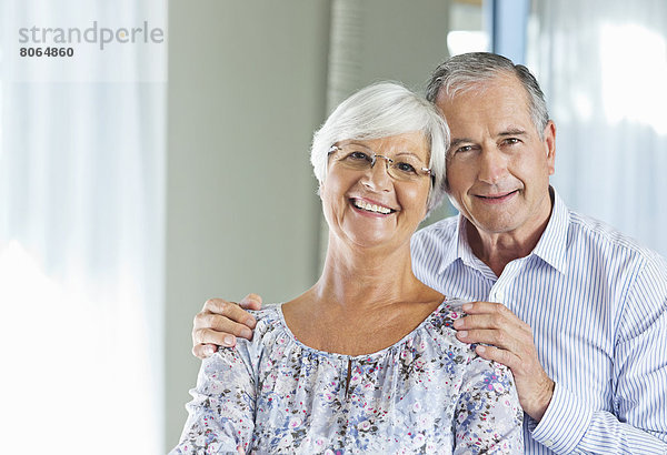 Älteres Paar lächelt zusammen im Haus