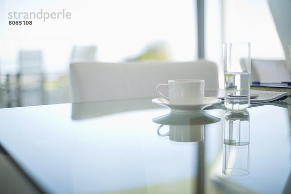 Kaffeetasse und Wasserglas auf dem Besprechungstisch