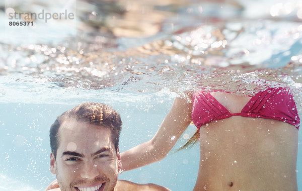 Pärchen spielen im Schwimmbad