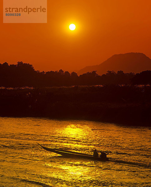 Ruea Hang Yao oder Long Tail Boat  Schnellboot auf dem Kok-River  bei Sonnenuntergang