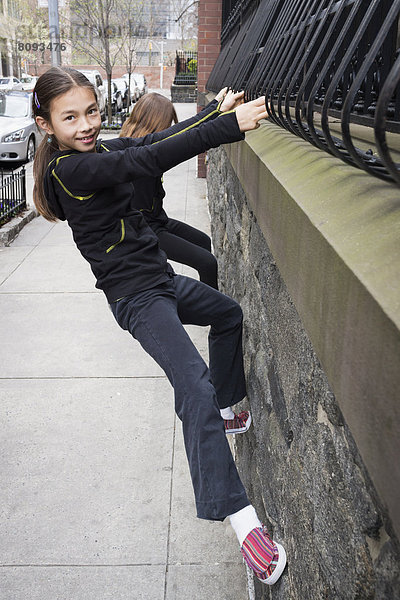 Mixed race girl playing on city street