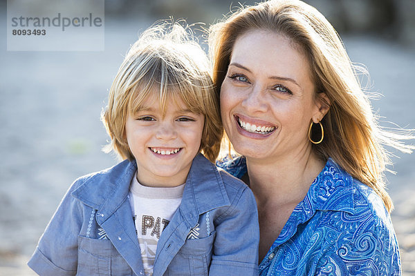 Hispanic mother and son smiling outdoors