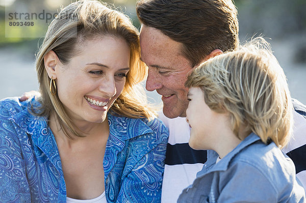 Family smiling together outdoors