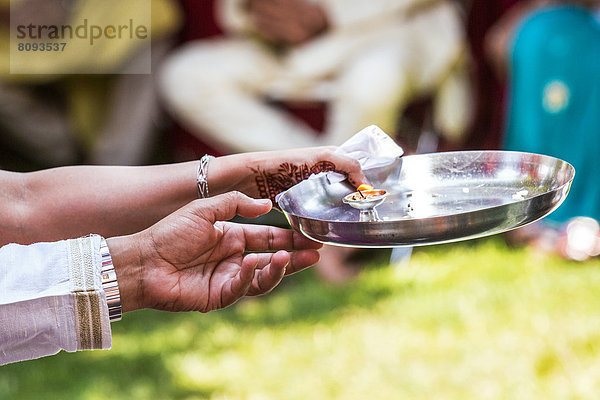 Couple holding bowl of water outdoors