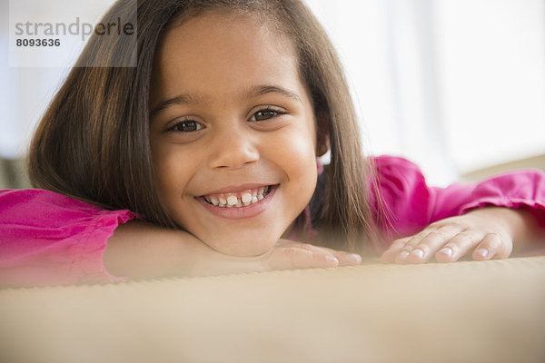 Hispanic girl smiling on counter