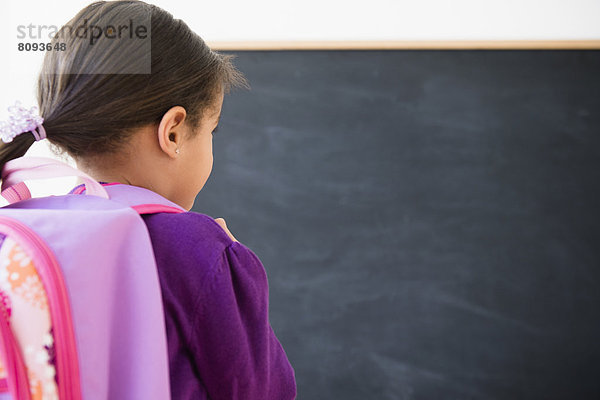 Hispanic girl wearing backpack