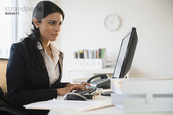 Indian businesswoman working at desk