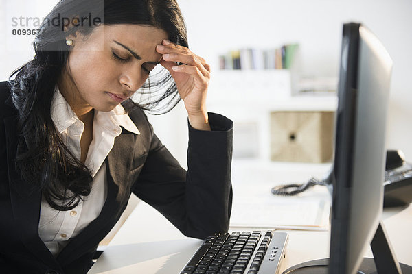 Indian businesswoman working at desk