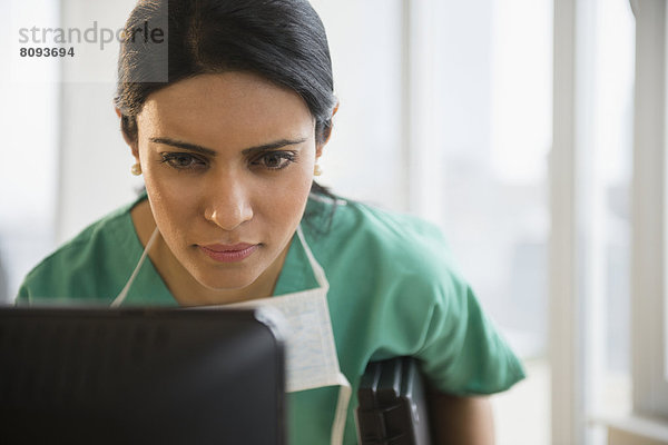 Indian nurse using laptop in office