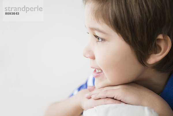 Hispanic boy resting chin on hands