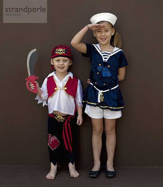 Caucasian children playing dress up