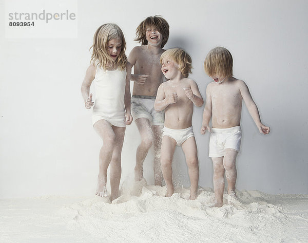 Caucasian children playing in flour