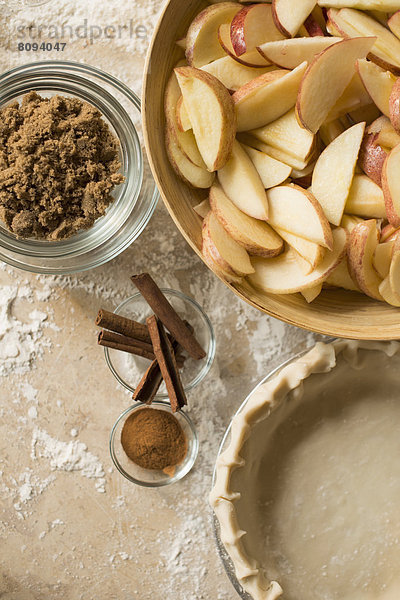 Close up of apples  spices and empty pie shell