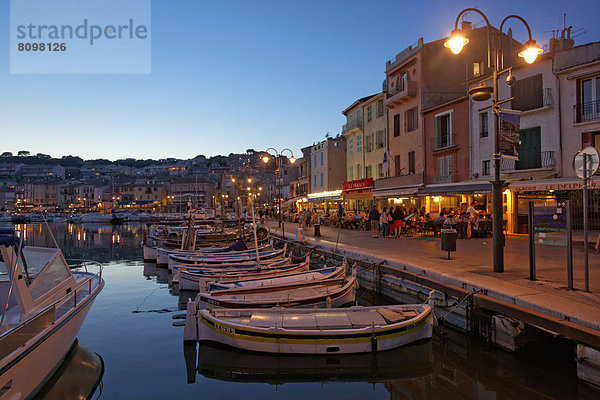 Harbour and historic town centre  small fishing boats  street cafes and restaurants  evening mood