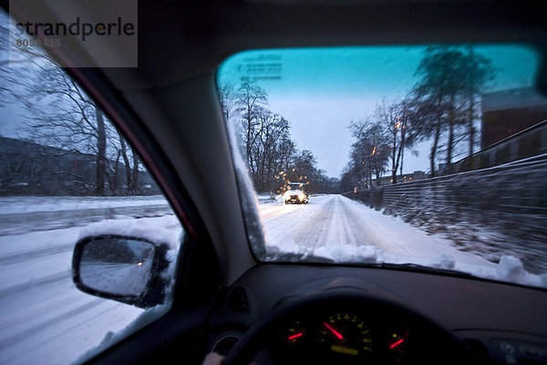 Autofahren bei Schnee in der Dämmerung