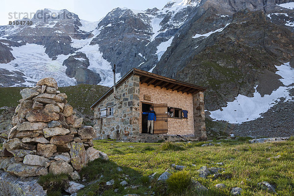 Zwei Wanderer an der Schmadrihütte  hinten Gletscherhorn und Mittaghorn