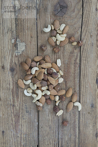 Mixed nuts on wooden board  close up