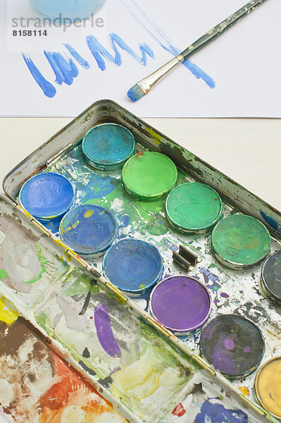 Watercolours with paintbrush  close up