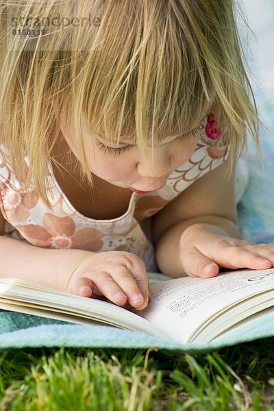 Germany  Baden Wuerttemberg  Girl reading book  close up