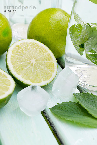 Preparing lime juice with mint and ice cube