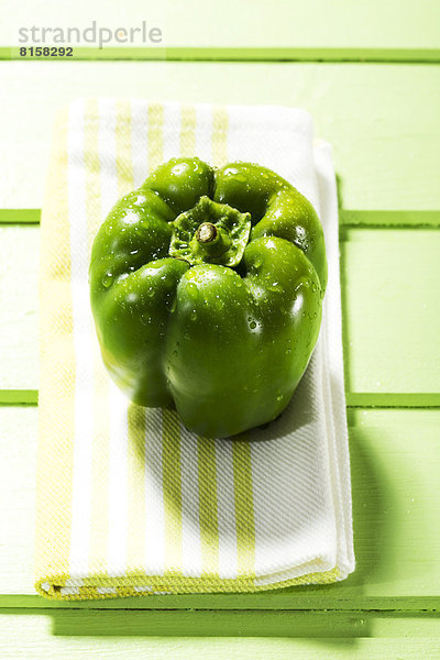 Green bell pepper on napkin  close up
