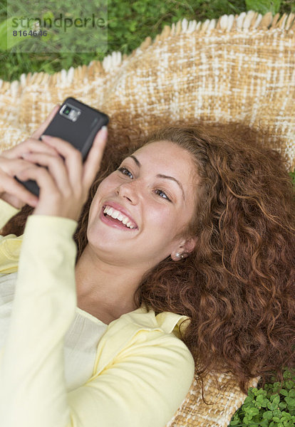 liegend  liegen  liegt  liegendes  liegender  liegende  daliegen  benutzen  Frau  Handy  Telefon  Gras