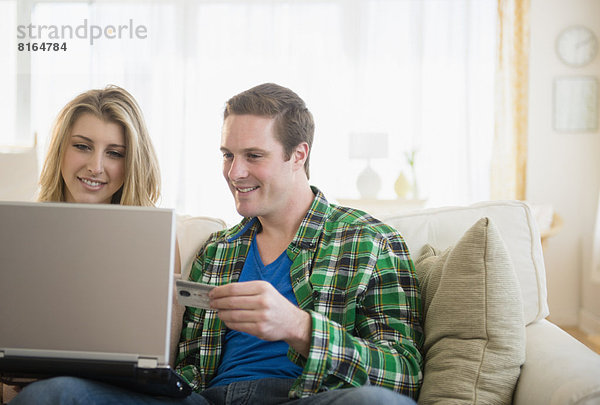 Couple using laptop  shopping online