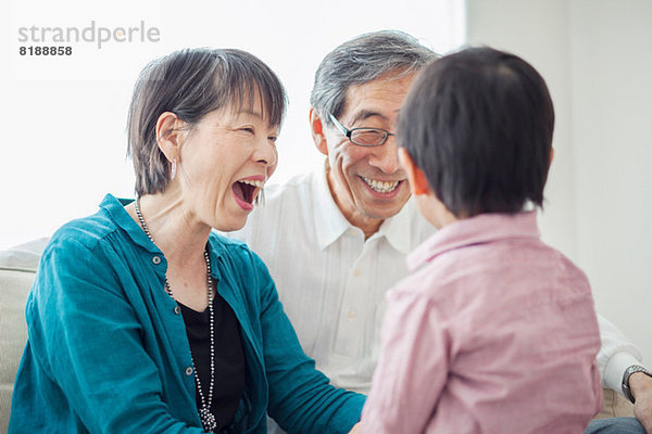 Großeltern mit Enkel lachend