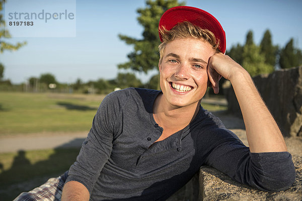 Germany  Young man in park  smiling