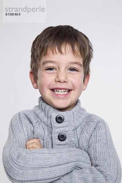 Portrait of boy against white background  smiling