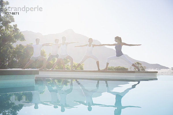 Menschen  die Yoga am Pool praktizieren