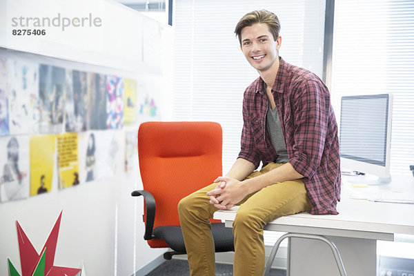 Geschäftsmann auf dem Schreibtisch im Büro sitzend