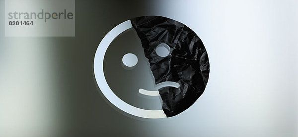 Grafik eines halb lächelnden und halb traurigen Gesichts vor einem Gradientenhintergrund
