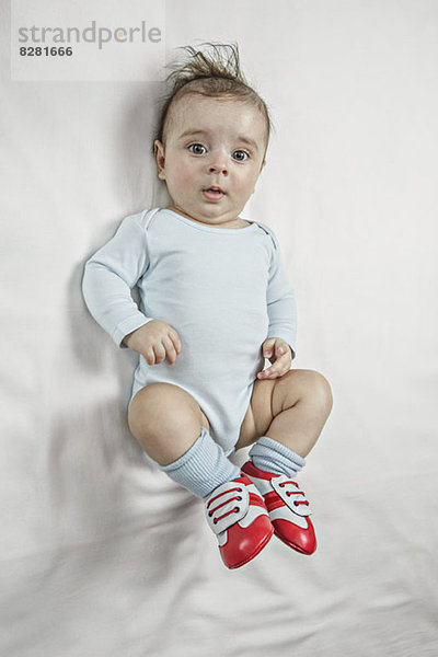 Ein kleiner Junge  der Fußballschuhe trägt.