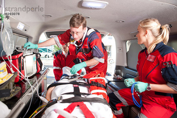 Rettungssanitäter kontrollieren Patienten im Krankenwagen