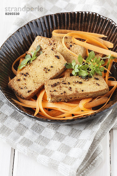 Fried marinated tofu with carrot salad  studio shot
