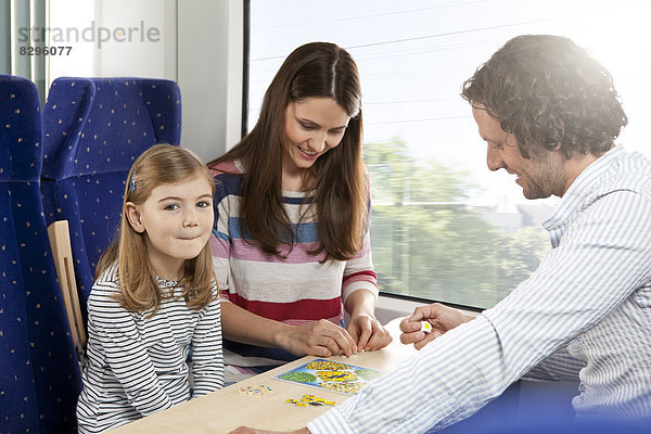 Happy family playing in a train